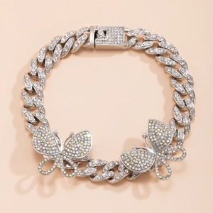 Detail of silver plated Cuban link anklet with iced out butterfly charms and rhinestones
