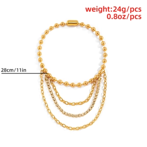 Detail view of multi-layer gold alloy tassel chain with rhinestones and plug buckle