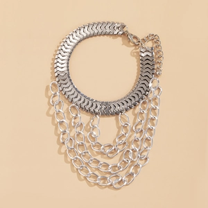 Detailed macro view of multi-layered silver metal tassel chains with lobster clasp closure