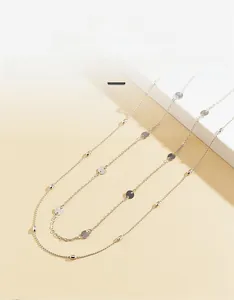 Macro shot of silver-tone double-layered body chain featuring polished round sequins