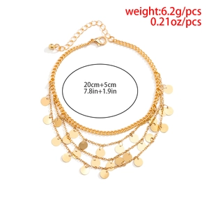 Detail of multilayered gold sequin star anklet showing 20cm length and 5cm extension
