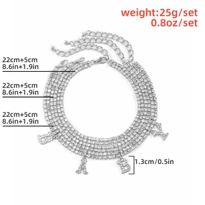 Detail view of multi-layer silver rhinestone anklet set featuring a BABY letter pendant