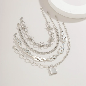 Detail view of silver multi-layer tassel chains with flame and padlock pendant charms