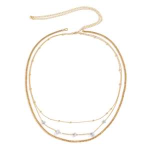 Detail of layered gold waist chain featuring small blue stones and adjustable lobster clasp
