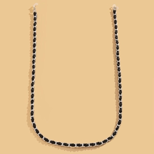 Detail of silver chain and black leather woven eyewear strap with silicone loops