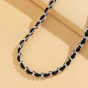 Detail of silver chain interwoven with black leather for eyewear or handbag straps