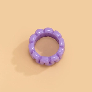 Detailed close-up of a chunky purple resin ring with a wavy bubble-style geometric design