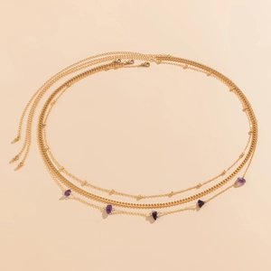 Close-up of triple-layered gold waist chain featuring purple amethyst stone pendants
