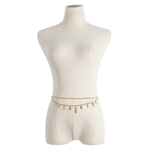 Detail of golden double-layer body chain with babygirl letters and sword pendant