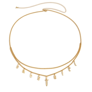 Detail of gold double-layer body chain featuring BABYGIRL letters and dagger pendant