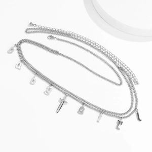Close-up of multilayer silver waist chain with BADGIRL letters and sword pendant