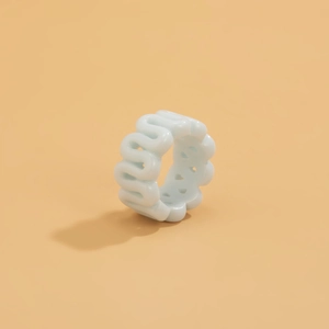 Close-up of light blue resin ring featuring a smooth wavy texture and hollow geometric design