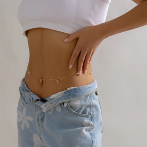 Close-up of gold double-layer waist chain with pink gravel stones on model's waist