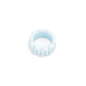 Close-up of light blue resin ring featuring a modern minimalist wavy textured design