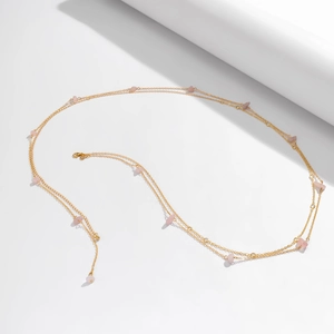 Detail of gold body chain with pink natural stone accents and secure lobster clasp
