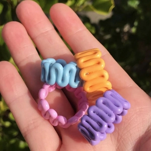 Set of four colorful wavy open rings in blue orange pink and purple resin finish