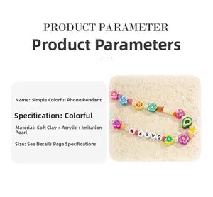 Macro shot of phone charm with colorful clay beads, faux pearls, and BABY letter beads