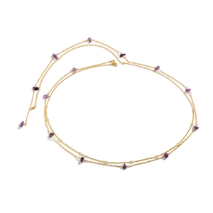 Detail of gold double-layer waist chain with purple stones and lobster clasp