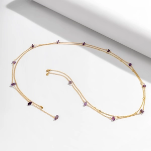 Detail of gold multi-layer body chain featuring purple natural stones and lobster clasp