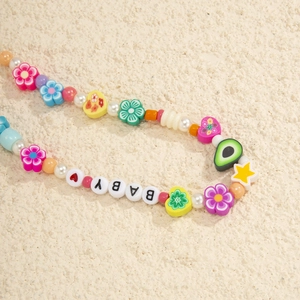 Detail of colorful beaded phone strap with resin flowers and BABY letter charms