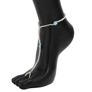 Detail of bohemian silver beaded anklet with toe ring featuring blue and pink flowers