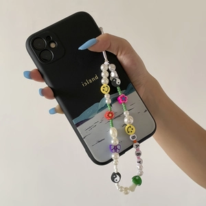 Fashionable beaded phone charm with pearls, smiley faces, and letters for a trendy look