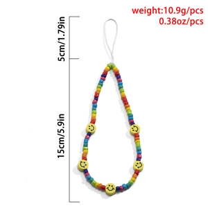 Detail of colorful macaron bead phone strap featuring yellow smiley face charms and white loop