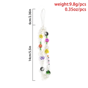 Close-up of Y2K beaded phone strap with faux pearls, smiley faces and BABY letter charms
