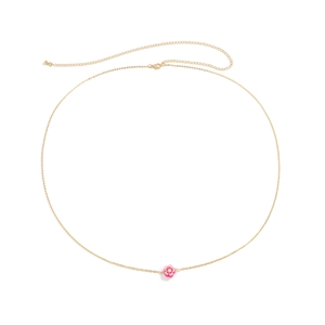 Dettaglio della catena dorata da vita con ciondolo a fiore rosa e chiusura a moschettone