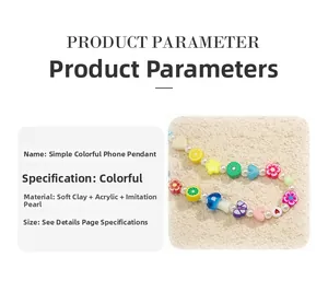 Close-up of a colorful beaded phone strap with fruit, flower, and butterfly charms