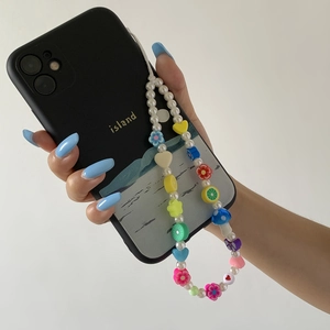 Beaded phone lanyard with mushroom and fruit charms on black island-style case