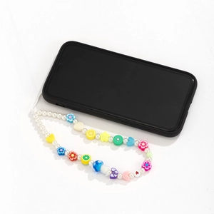 Detail view of colorful resin charms with pearls on a smartphone lanyard strap