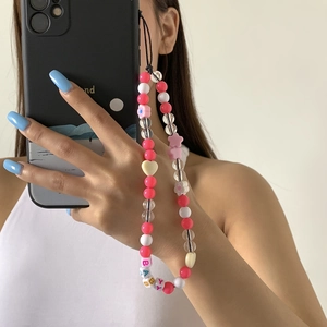 Pink and white beaded phone charm featuring flower shapes and BABY letter beads