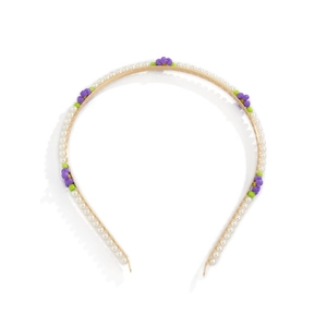 Detail of floral headband with white pearls and colorful beaded daisy decorations