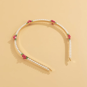 Detail of floral beaded headband with white faux pearls and red bead flower accents