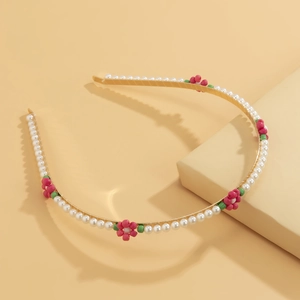 Detail of beaded floral headband with white pearls and pink bead flowers on gold metal frame
