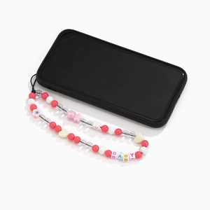 Detail of beaded phone strap with floral charms and BABY letter beads in pink and white
