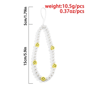 Handmade beaded phone strap with white pearls and yellow smiley face charms on white background