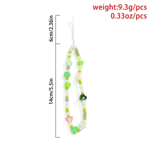 Beaded wrist strap with green heart, purple beads, and mushroom charm for smartphones