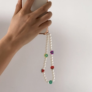 Handmade beaded phone strap with white pearls and colorful clay fruit charms for women
