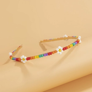 Detail of colorful woven daisy headband with rainbow beads and floral accents