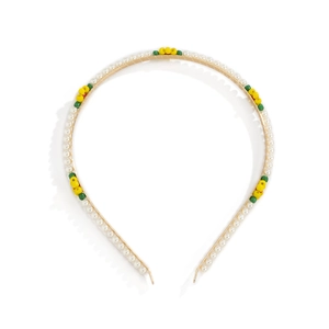 Detailed macro view of gold metal headband with white faux pearls and colorful beads