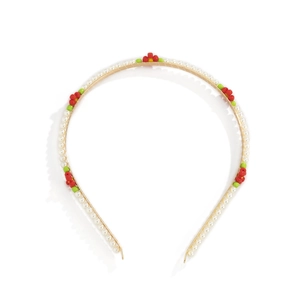 Detail of flower headband with white pearls and red and green daisy floral accents