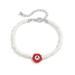 Detalle de pulsera de cuentas de colores con dije de letra A y cierre de langosta