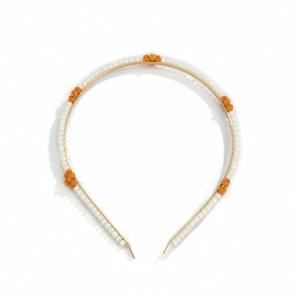Close-up of golden metal headband with delicate orange and white beaded daisies