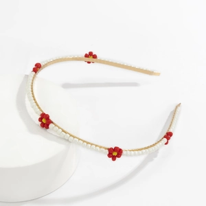 Detail of woven floral headband with white pearls and colorful beaded daisies