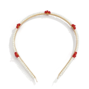 Detailed close-up of handmade beaded daisy headband with white pearls and red flowers