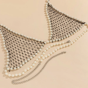 Detail view of woven pearl body chain with black fishnet mesh and rhinestone accents