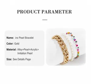 Detailed view of stacked Cuban chain, faux pearls, and colorful BABY letter bead bracelets