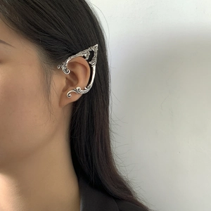 Detail of silver elven ear cuff with vintage carved textures on model side view
